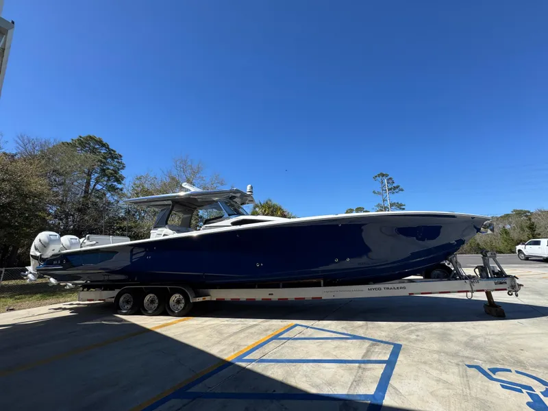 Slide: The Image of 2018 Nor-Tech 452 Super Fish boat on trailer, parked outdoors under clear blue sky. - 12