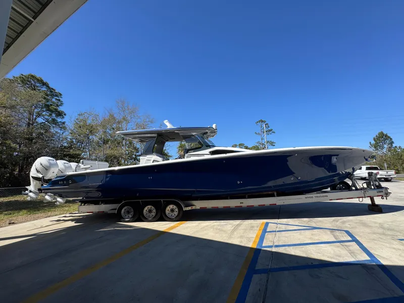 Slide: The Image of 2018 Nor-Tech 452 Super Fish boat on trailer, parked outdoors under clear blue sky. - 13