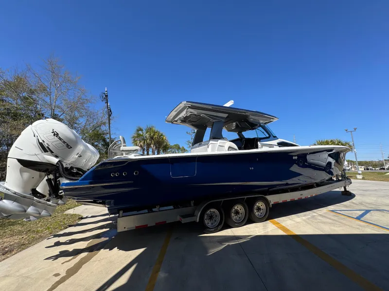 Slide: The Image of 2018 Nor-Tech 452 Super Fish boat on trailer, blue hull, triple outboard engines. - 14