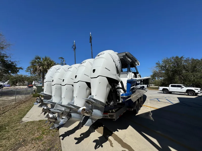 Slide: The Image of 2018 Nor-Tech 452 Super Fish boat with multiple outboard engines, parked outdoors. - 16