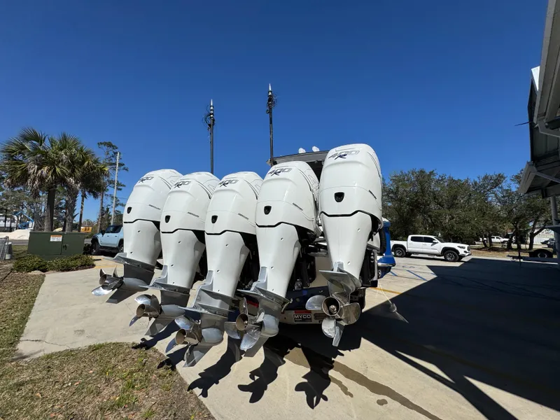 Slide: The Image of Five powerful outboard motors on a 2018 Nor-Tech 452 Super Fish boat, parked outdoors. - 17