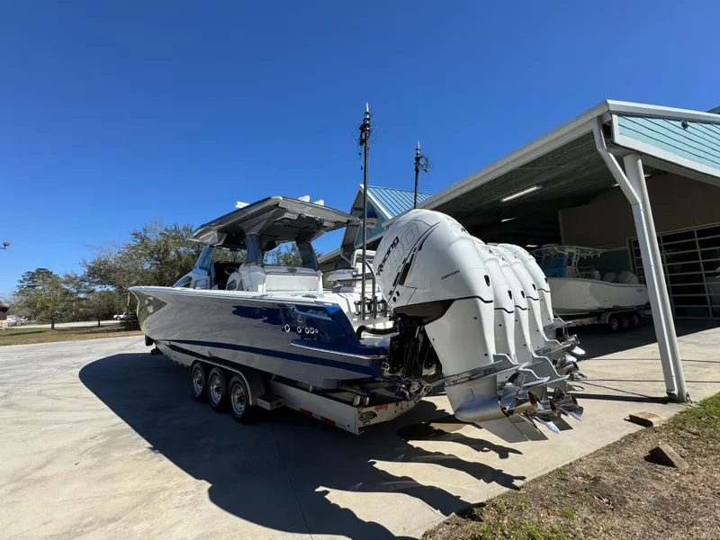Slide: The Image of 2018 Nor-Tech 452 Super Fish boat with multiple outboard engines on a trailer. - 19