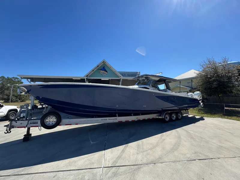 Slide: The Image of 2018 Nor-Tech 452 Super Fish boat on trailer, parked outdoors under clear blue sky. - 2