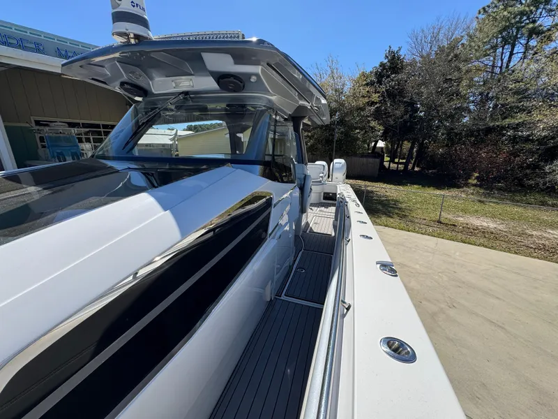 Slide: The Image of 2018 Nor-Tech 452 Super Fish boat, sleek design, docked outdoors on a sunny day. - 29