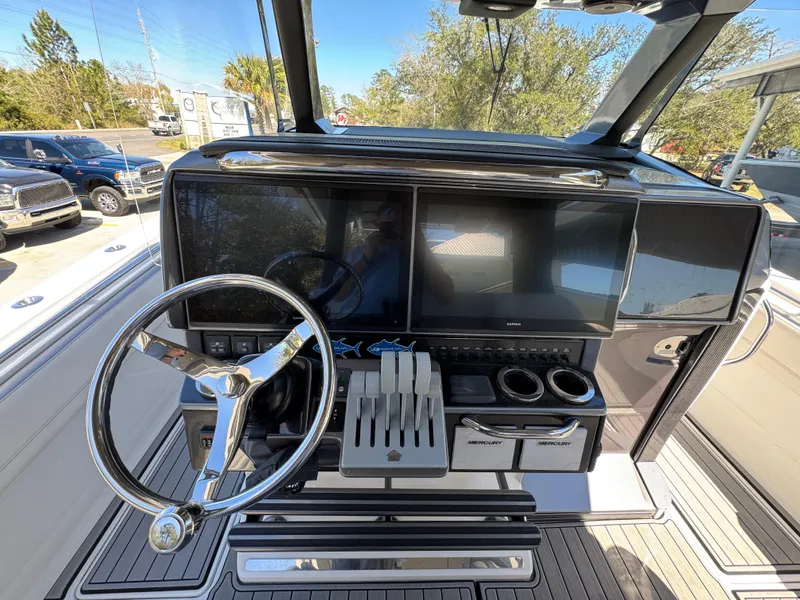 Slide: The Image of 2018 Nor-Tech 452 Super Fish dashboard with steering wheel and navigation screens. - 34