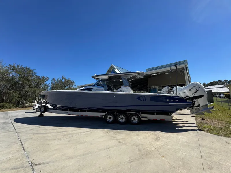 Slide: The Image of 2018 Nor-Tech 452 Super Fish boat on trailer, parked outdoors under clear blue sky. - 4