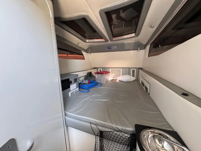 Slide: The Image of Interior cabin of 2018 Nor-Tech 452 Super Fish boat, featuring a cozy sleeping area. - 42