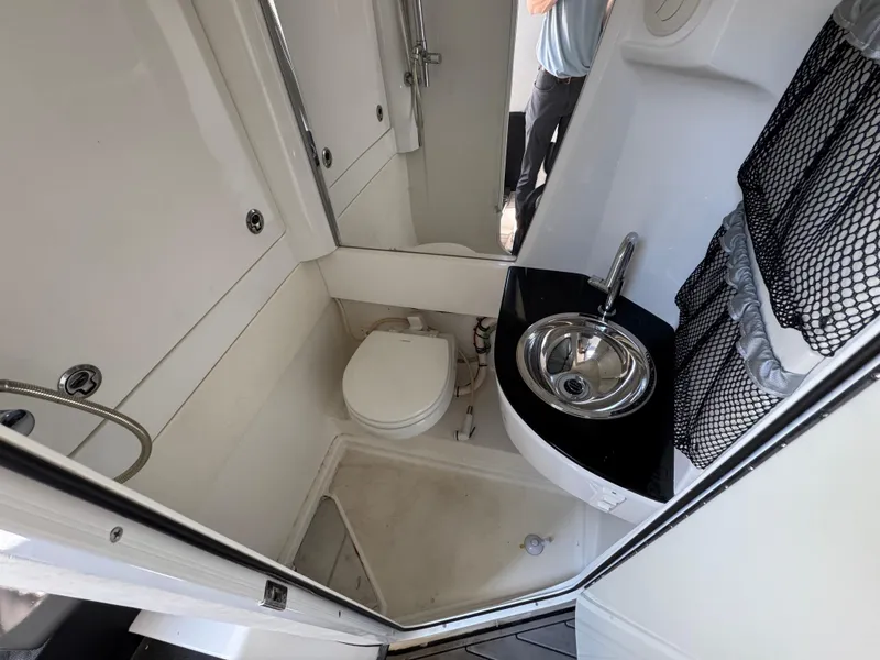 Slide: The Image of 2018 Nor-Tech 452 Super Fish boat bathroom with toilet, sink, and shower area. - 43