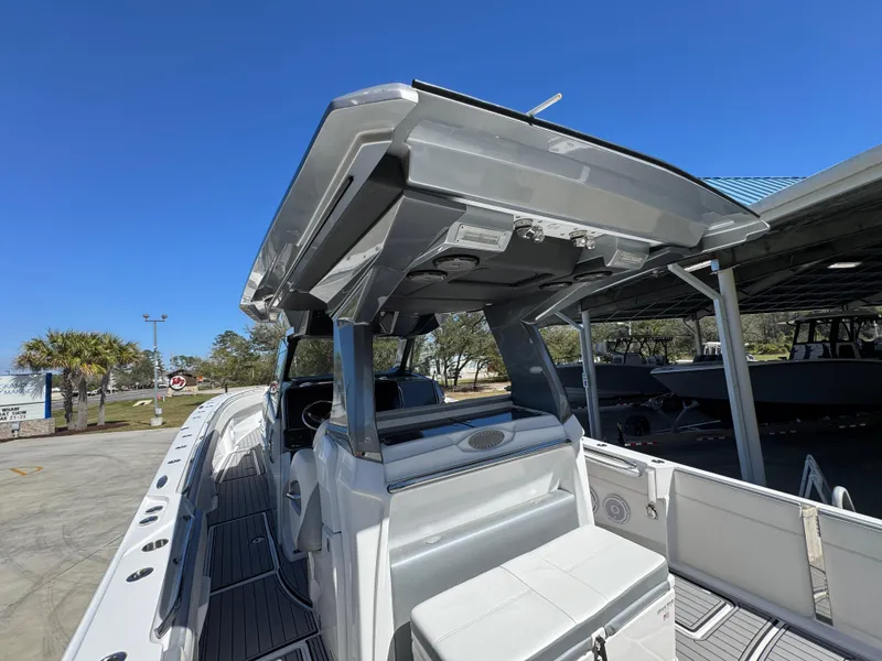 Slide: The Image of 2018 Nor-Tech 452 Super Fish boat with sleek design and spacious deck under clear blue sky. - 46