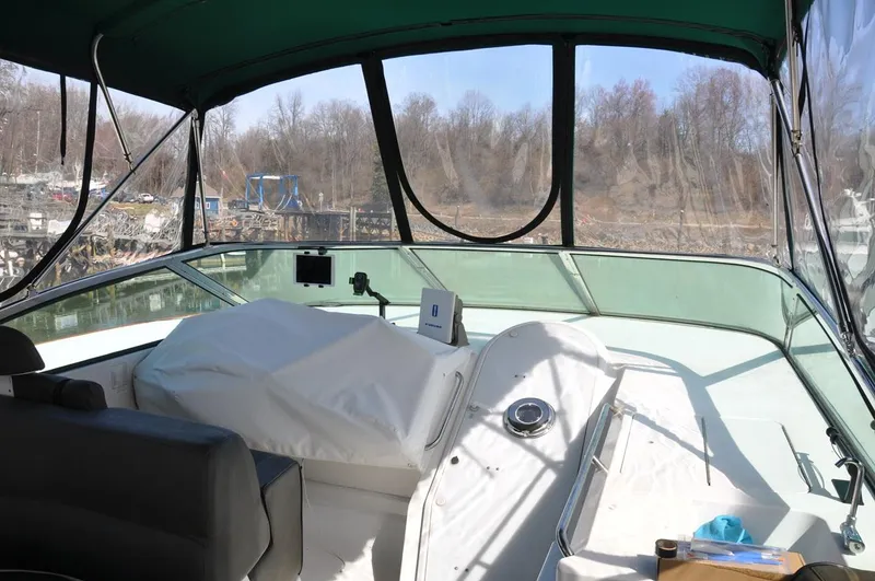 Slide: The Image of Pilothouse interior of 2000 Carver 530 Voyager yacht with covered controls and scenic view. - 13