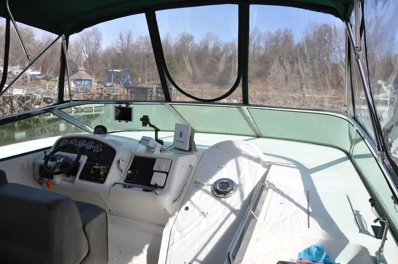 Slide: The Image of 2000 Carver 530 Voyager Pilothouse interior with steering controls and navigation equipment. - 14