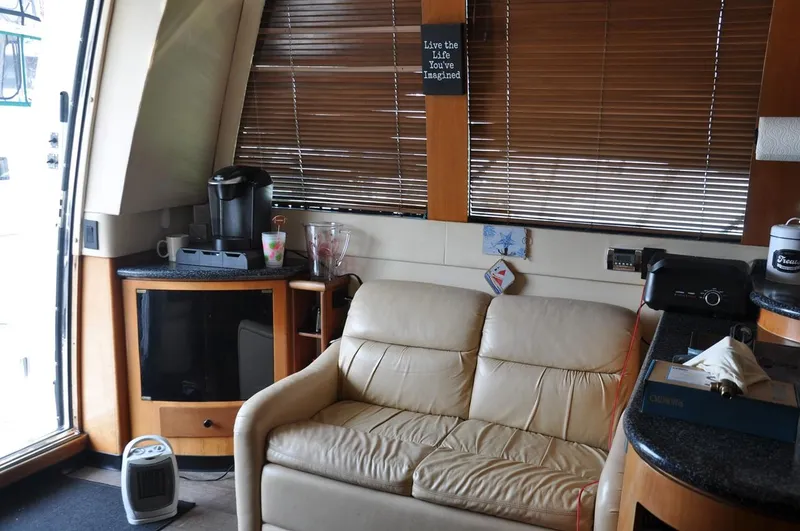 Slide: The Image of Interior of 2000 Carver 530 Voyager Pilothouse with sofa, TV, and coffee maker. - 18