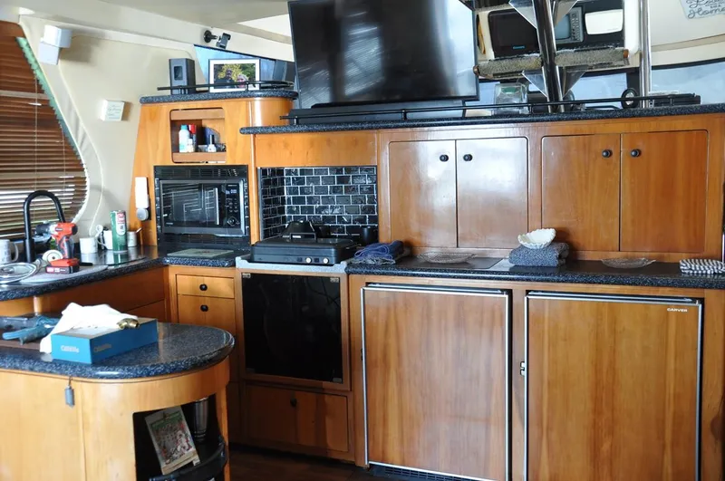 Slide: The Image of Interior of 2000 Carver 530 Voyager Pilothouse with wooden cabinetry and modern appliances. - 19