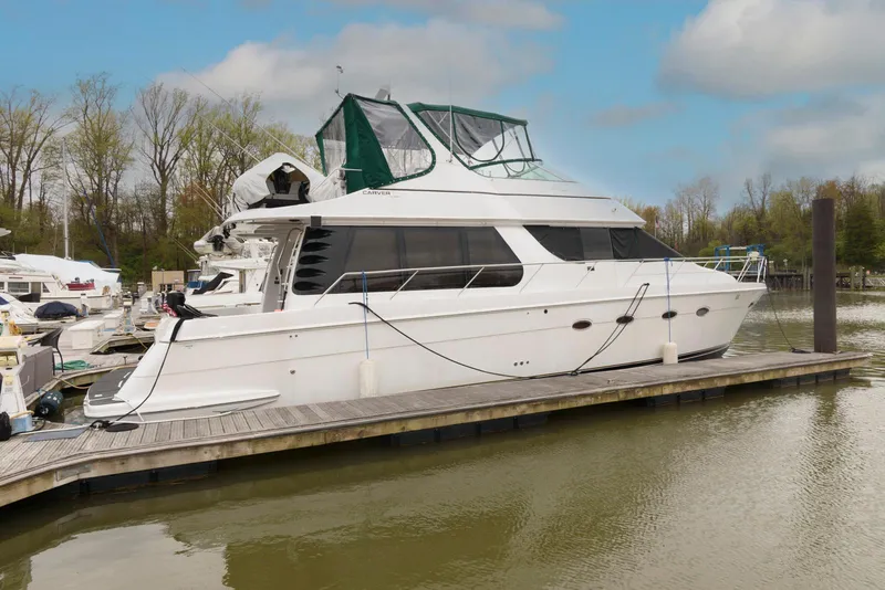 Slide: The Image of 2000 Carver 530 Voyager Pilothouse yacht docked at marina, side view. - 2