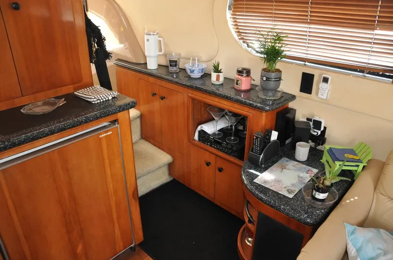 Slide: The Image of Interior of 2000 Carver 530 Voyager Pilothouse with wooden cabinetry and countertop decor. - 21