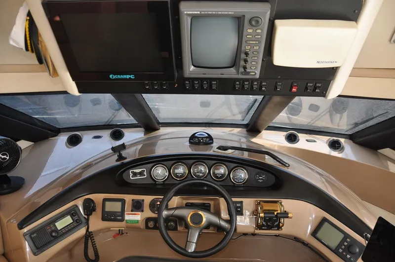 Slide: The Image of Pilothouse interior of 2000 Carver 530 Voyager, featuring navigation equipment and steering controls. - 23