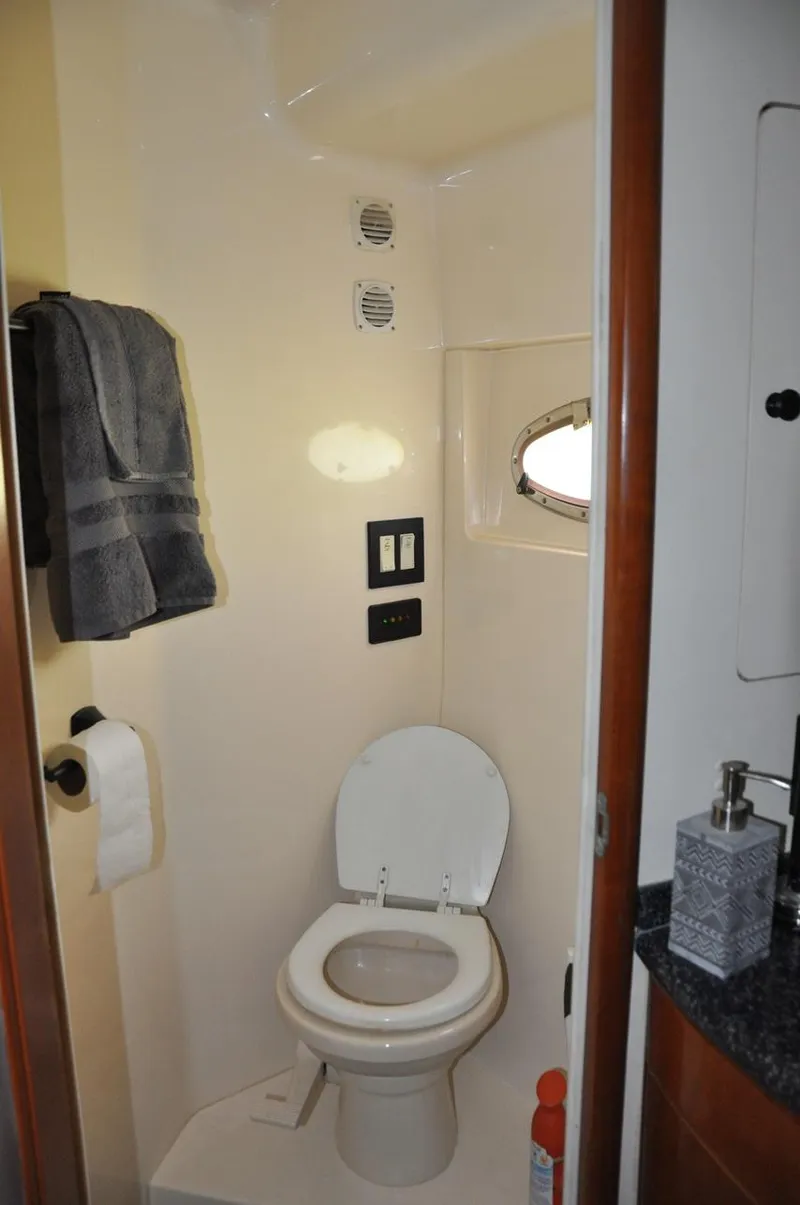 Slide: The Image of Bathroom in 2000 Carver 530 Voyager Pilothouse yacht with toilet and towel rack. - 29