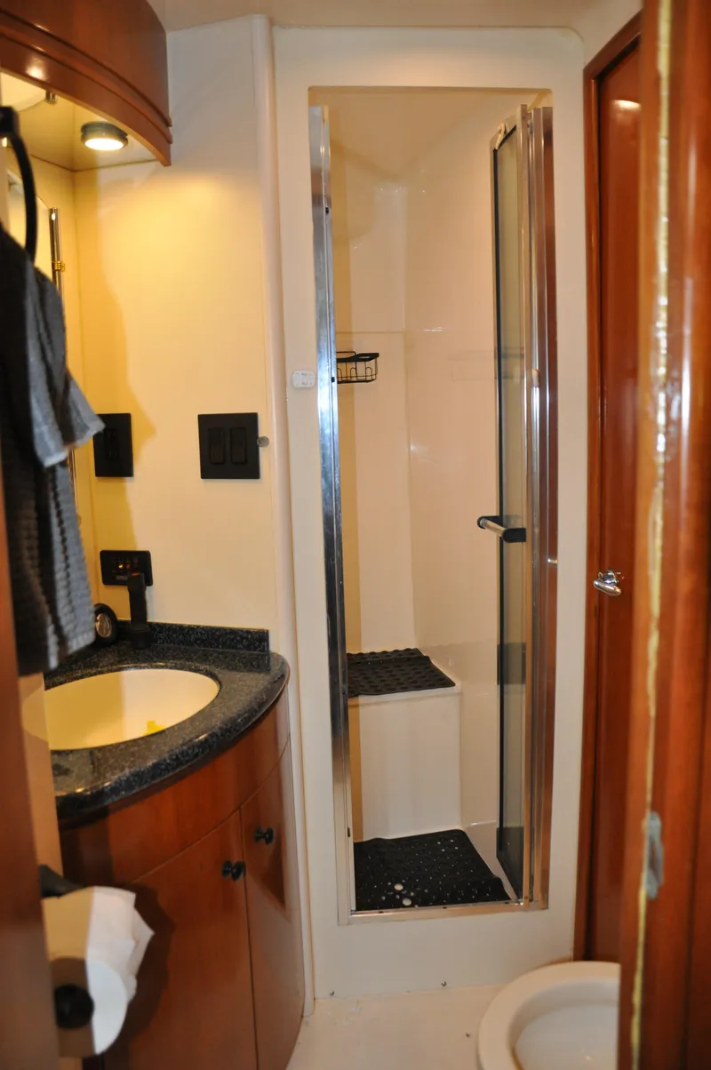 Slide: The Image of Bathroom interior of 2000 Carver 530 Voyager Pilothouse yacht with shower and sink. - 34