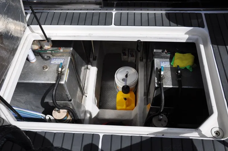 Slide: The Image of Engine compartment of 2000 Carver 530 Voyager Pilothouse with fuel tanks and maintenance supplies. - 38