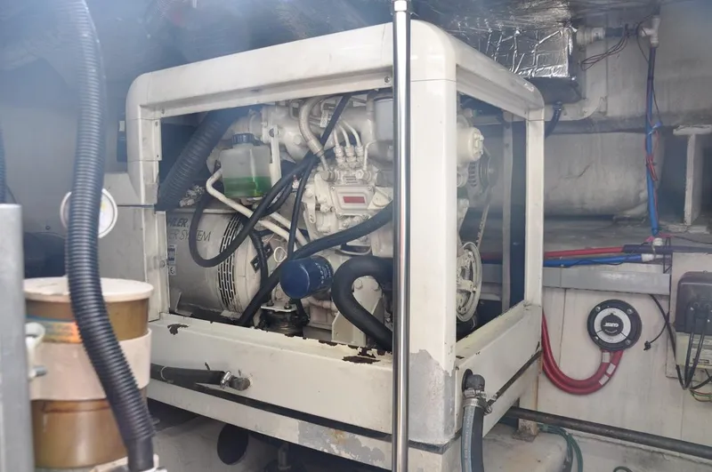 Slide: The Image of Engine room of 2000 Carver 530 Voyager Pilothouse with visible machinery and wiring. - 39