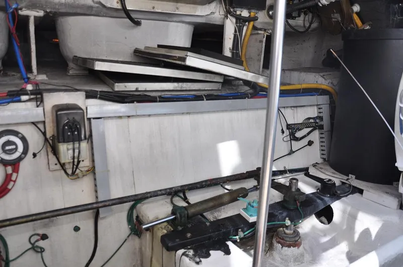 Slide: The Image of Engine room of 2000 Carver 530 Voyager Pilothouse with mechanical components and wiring. - 40