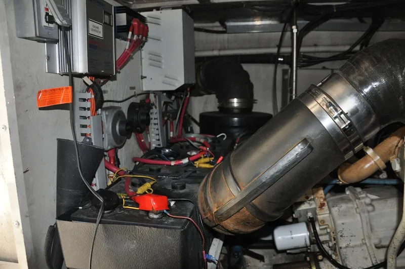 Slide: The Image of Engine room of 2000 Carver 530 Voyager Pilothouse with mechanical components and wiring. - 41