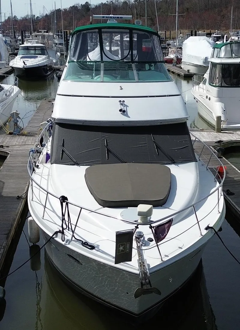 Slide: The Image of 2000 Carver 530 Voyager Pilothouse yacht docked at marina, front view. - 5