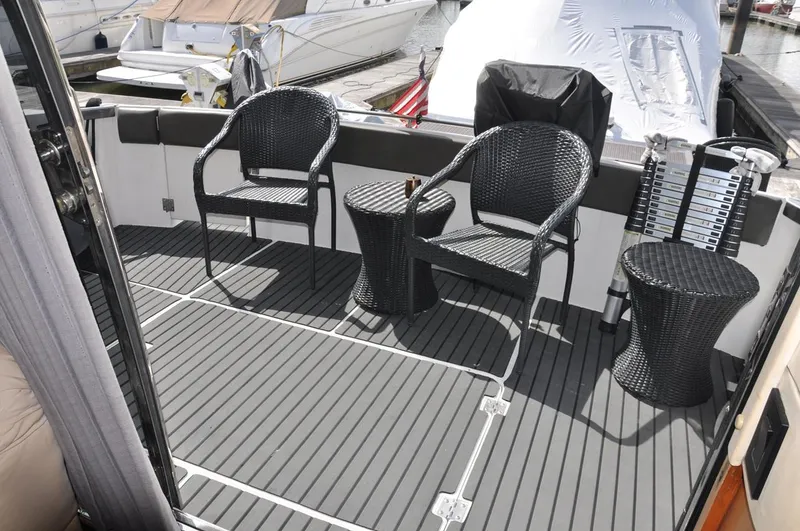 Slide: The Image of Outdoor seating area on 2000 Carver 530 Voyager Pilothouse yacht with wicker chairs and tables. - 9