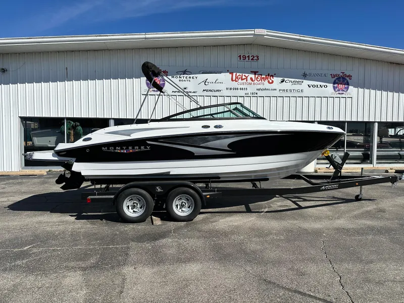 The Image of 2025 Monterey M20 boat on trailer, parked outside dealership under clear blue sky. - 1
