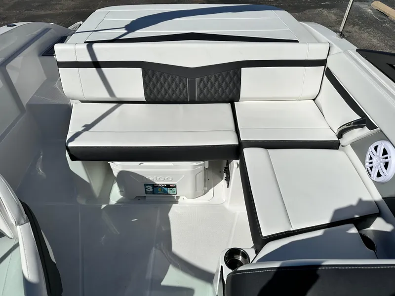 Slide: The Image of 2025 Monterey M20 boat interior with white seating and storage compartment. - 11