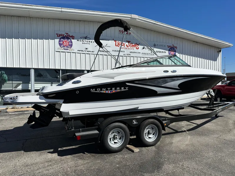 Slide: The Image of 2025 Monterey M20 boat on trailer outside dealership. - 2