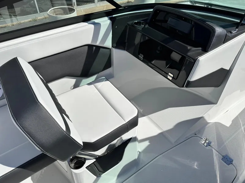 Slide: The Image of 2025 Monterey M20 boat interior with sleek black and white seating and modern dashboard. - 6