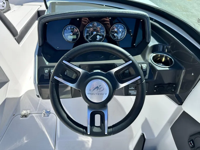 Slide: The Image of Steering wheel and dashboard of 2025 Monterey M20 boat, featuring modern controls and gauges. - 8