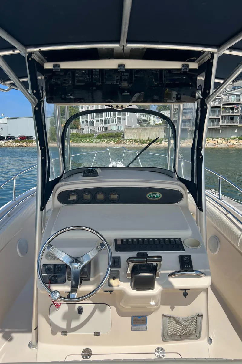 Slide: The Image of 2005 Grady-White 283 RELEASE boat cockpit with steering wheel and controls. - 11