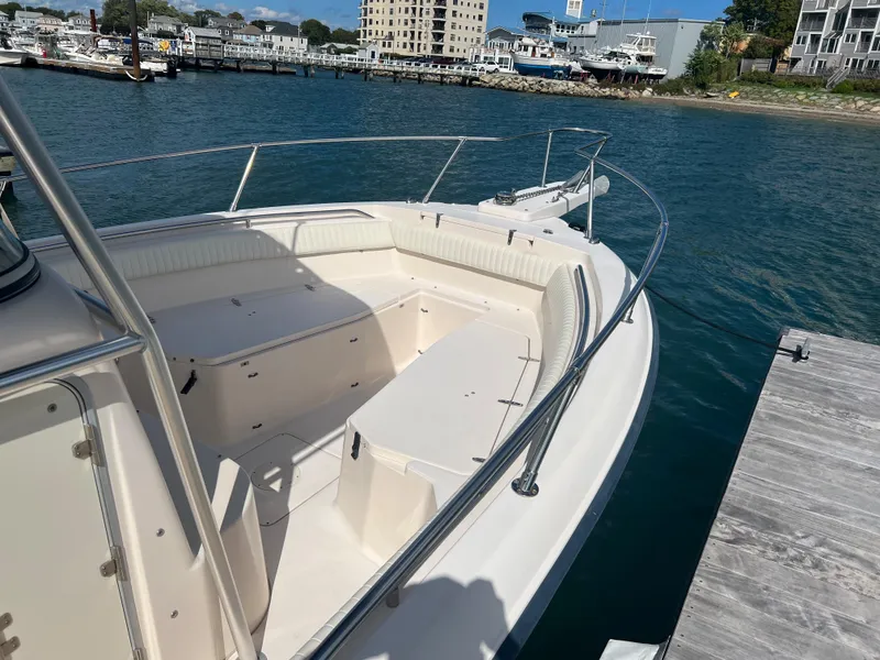 Slide: The Image of 2005 Grady-White 283 RELEASE boat docked by the water, showcasing spacious seating. - 13