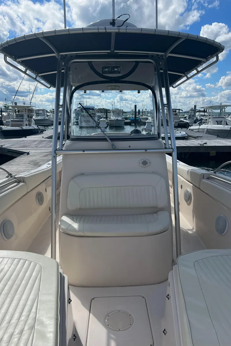 Slide: The Image of 2005 Grady-White 283 RELEASE boat interior with seating, docked under a blue sky. - 15