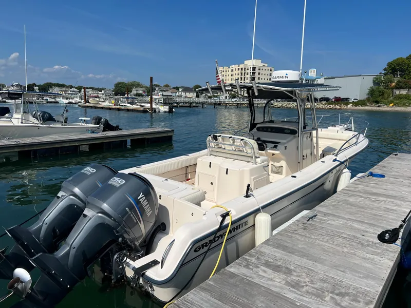 Slide: The Image of 2005 Grady-White 283 RELEASE boat docked with twin Yamaha engines, clear sky, marina background. - 3