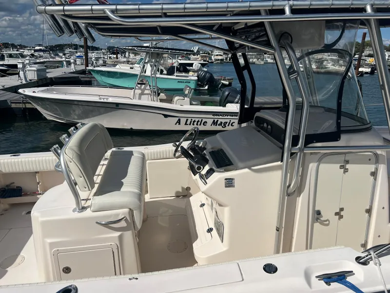 Slide: The Image of 2005 Grady-White 283 RELEASE boat interior at marina, featuring helm and seating area. - 4