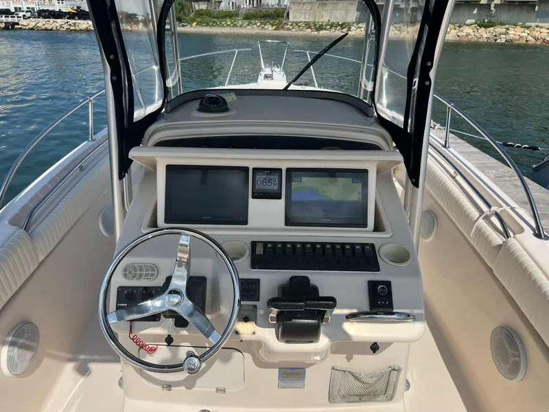 Slide: The Image of 2005 Grady-White 283 RELEASE boat dashboard with steering wheel and navigation screens. - 9