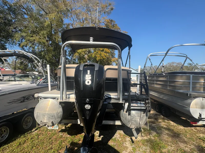 Slide: The Image of 2019 Misty Harbor 2285 Biscayne Bay CE pontoon boat with 150 HP engine, parked outdoors. - 1