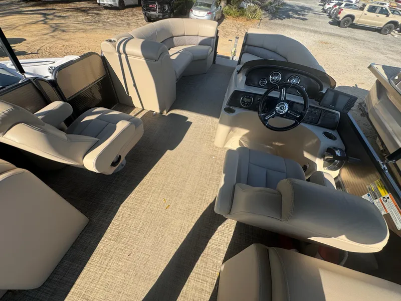 Slide: The Image of 2019 Misty Harbor 2285 Biscayne Bay CE pontoon boat interior with beige seating and steering console. - 5