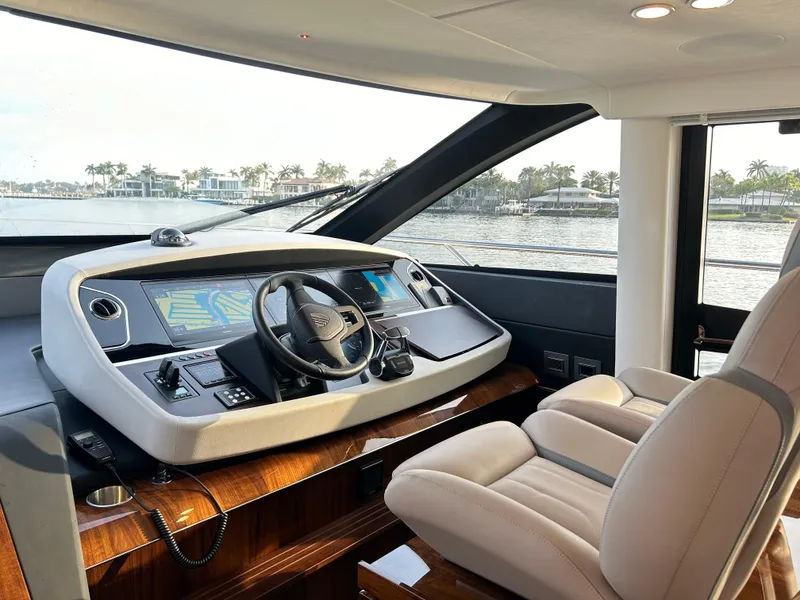 Slide: The Image of 2024 Fairline Squadron 68 yacht helm with modern controls and luxurious seating. - 10