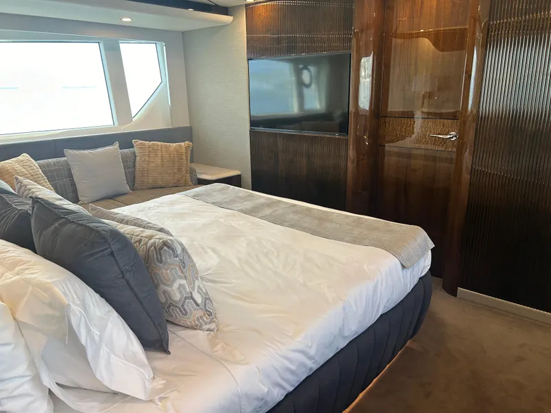 Slide: The Image of Luxurious bedroom interior of 2024 Fairline Squadron 68 yacht with modern decor and large window. - 13