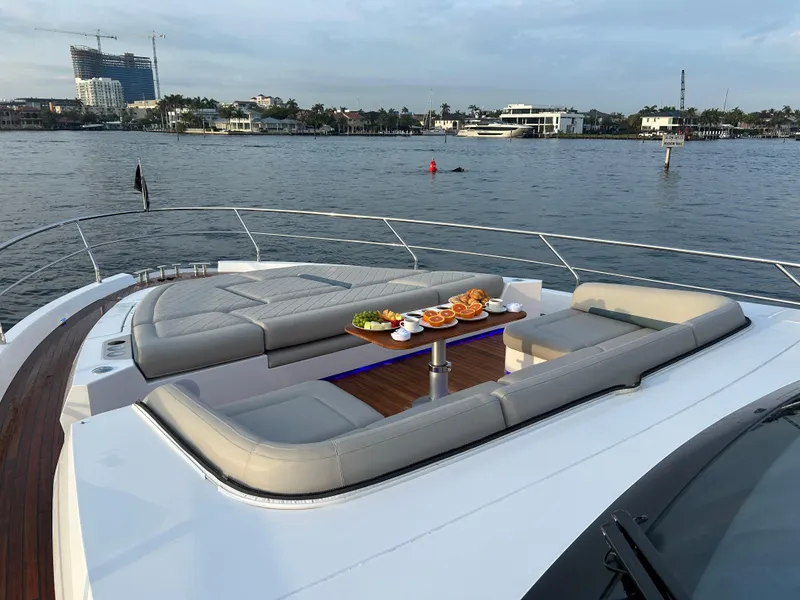 Slide: The Image of Luxurious 2024 Fairline Squadron 68 yacht with elegant deck seating and waterfront view. - 27