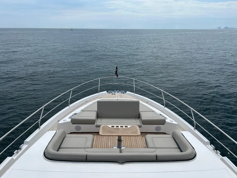 Slide: The Image of 2024 Fairline Squadron 68 yacht bow with luxurious seating, overlooking the ocean. - 28