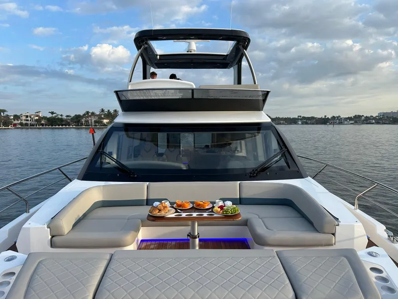 Slide: The Image of 2024 Fairline Squadron 68 yacht with elegant seating and dining setup on deck. - 29