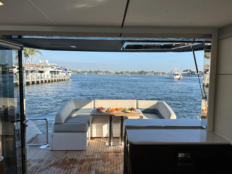 Slide: The Image of 2024 Fairline Squadron 68 yacht with elegant deck seating and scenic waterfront view. - 3
