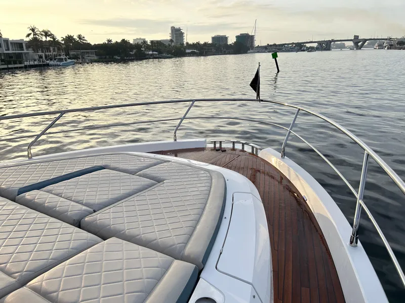 Slide: The Image of 2024 Fairline Squadron 68 yacht with luxurious deck, cruising on calm waters at sunset. - 31