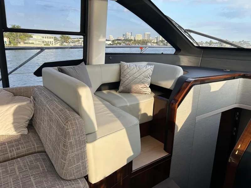 Slide: The Image of Luxurious interior of 2024 Fairline Squadron 68 yacht with elegant seating and waterfront view. - 6