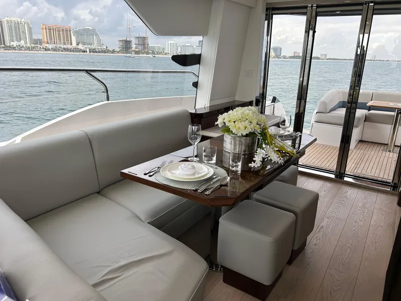 Slide: The Image of Luxurious interior of 2024 Fairline Squadron 68 yacht with elegant dining setup and sea view. - 7